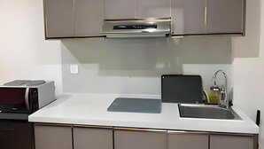 A modern kitchen with stainless steel cabinets, a built-in oven, and a sink with a faucet.