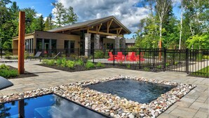 A modern building with a stone facade and a covered patio area.