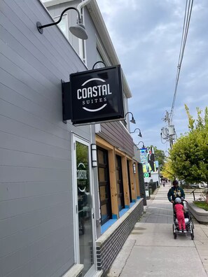 A building with a sign reading "Coastal Suites" and a visible window with the same sign. - Coastal Suites  (Grand Bend)