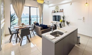 Family Apartment, 2 Bedrooms, Balcony, City View | Living area | 55-inch Smart TV with cable channels