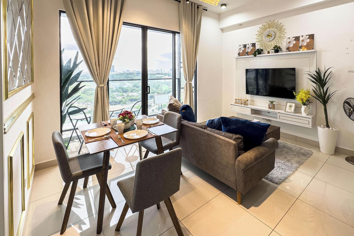 A modern living room with a dining area, a large TV, and a balcony with a city view.