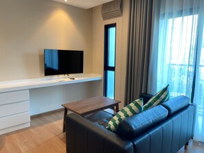 Premier Condo, 1 Bedroom | Living area | Flat-screen TV - The Title V by The Esquire (Rawai)