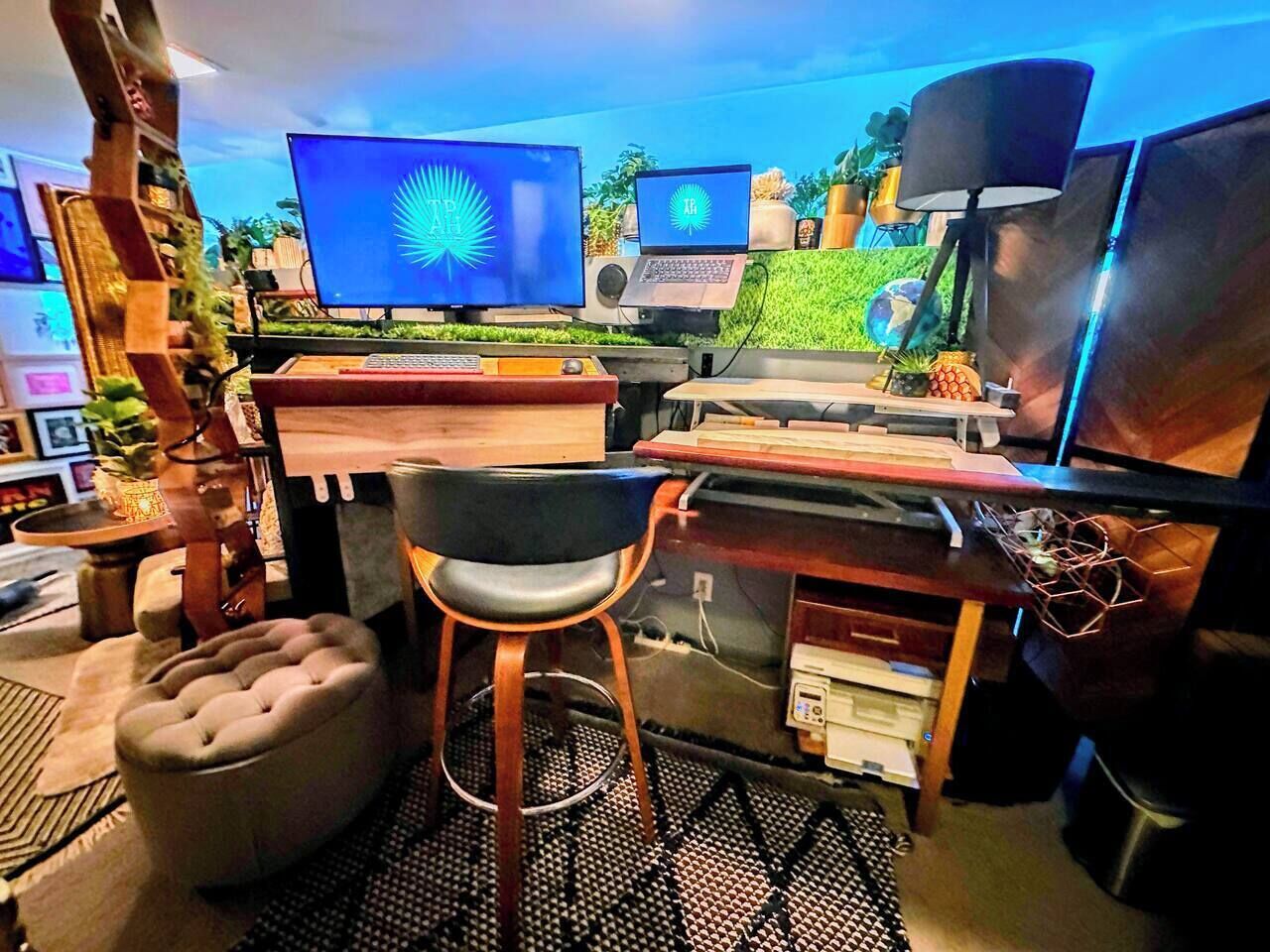 A home office with a desk, two monitors, a laptop, and a comfortable chair.