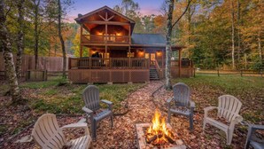 A cabin with a fire pit and outdoor seating, surrounded by trees. - Private Cozy Cabin w/ Hot Tub in Blue Ridge! (Blue Ridge)