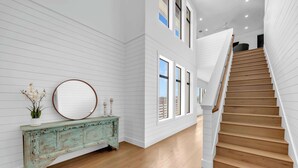 A staircase with wooden steps and white walls. - Tranquil Tides-Luxury Waterfront home, pool & dock (Kingsland)