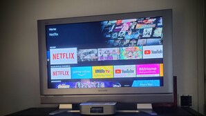 A television displaying a streaming service interface with options like Netflix, Prime Video, and YouTube.