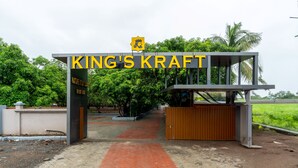 A gated entrance to King's Kraft Nature Study Center with a red brick pathway leading to the gate. - Kings Kraft River Side Resort  (Talala)