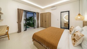A modern bedroom with a large bed, a wooden wardrobe, a desk, and a view of the outdoors.