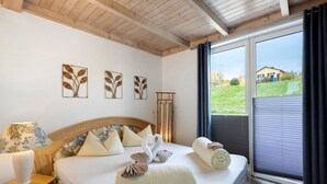 A bedroom with a bed, pillows, a nightstand, and a window with a view. - Holiday Apartment 'Seeschwalbe - Marina Mücheln' with Lake View, Wi-Fi & Air Conditioning (Mücheln (Geiseltal))