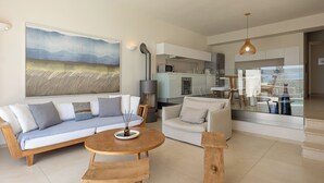 Un salon moderne avec un canapé, une table basse et une petite table d’appoint en bois.