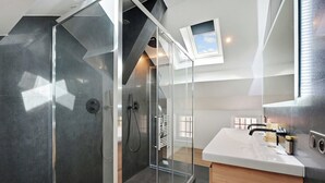 A modern bathroom with a glass-enclosed shower, a white sink, and a small window above the mirror. - Superb apartment - 1BD/4P - Aubervilliers (Aubervilliers)