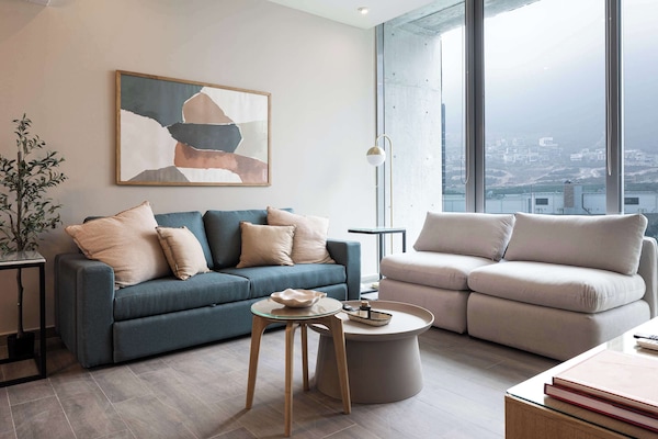 Relax in the living room with a sofa bed and stunning mountain scenery.