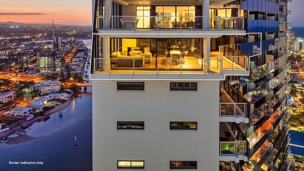 A high-rise building with multiple balconies and a view of a cityscape at dusk. - Sub-Penthouse Dream in Circle on Cavill (Gold Coast)