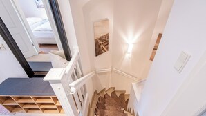 A staircase with a built-in bench, a wall-mounted light, and a framed picture.