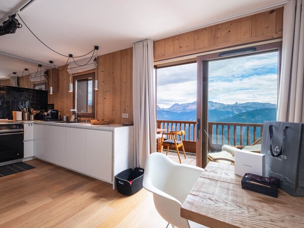 Enjoy meals at the dining table in this well-appointed kitchen with a scenic mountain view.