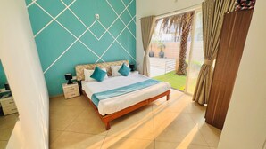 A bedroom with a bed, nightstand, and a view of a garden through a window. - Ashford 4 BHK With Pvt Pool By Stellar Stays (Mawal)