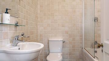 A bathroom with a sink, toilet, and shower.