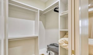 A walk-in closet with open doors, revealing shelves and hanging space. - Stylish New Build with Pool, Spa, and Design (North Port)