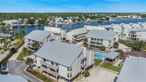 A coastal residential area with modern houses, a swimming pool, and a marina.
