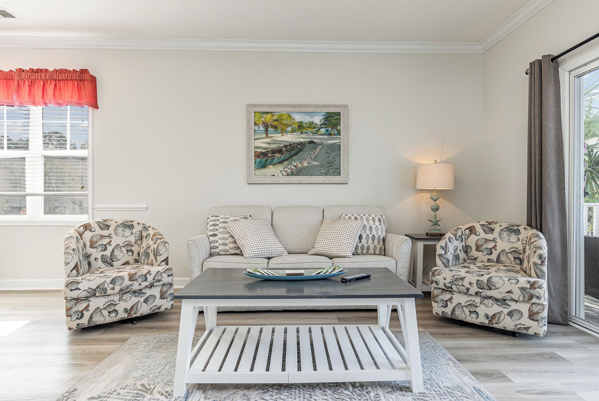 A living room with a sofa set, a coffee table, and a painting on the wall.
