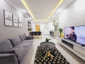 Deluxe Apartment, 3 Bedrooms | Living area | 75-cm Smart TV with digital channels, Netflix, streaming services - Diamond Suite in Scenic Valley 2 (Ho Chi Minh City)