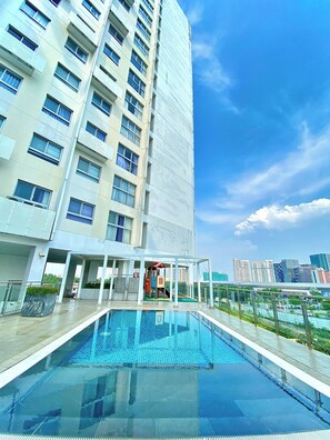 Enjoy a refreshing swim in the pool surrounded by a glass barrier and take in the views of the city from the building's balconies.
