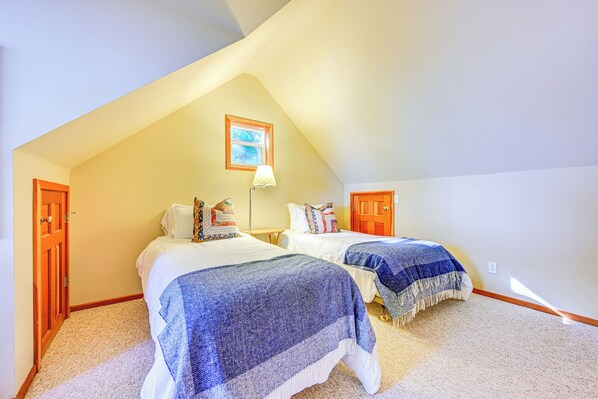 A bedroom with two beds, a window, and a door. - Hood Canal Home w/ Stunning Views & Private Beach (Brinnon)