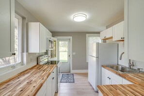 A kitchen with white cabinets, a wooden countertop, a built-in oven, and a refrigerator. - 2 Mi to Windham Mountain: Scenic Home w/ Fire Pit! (Windham)
