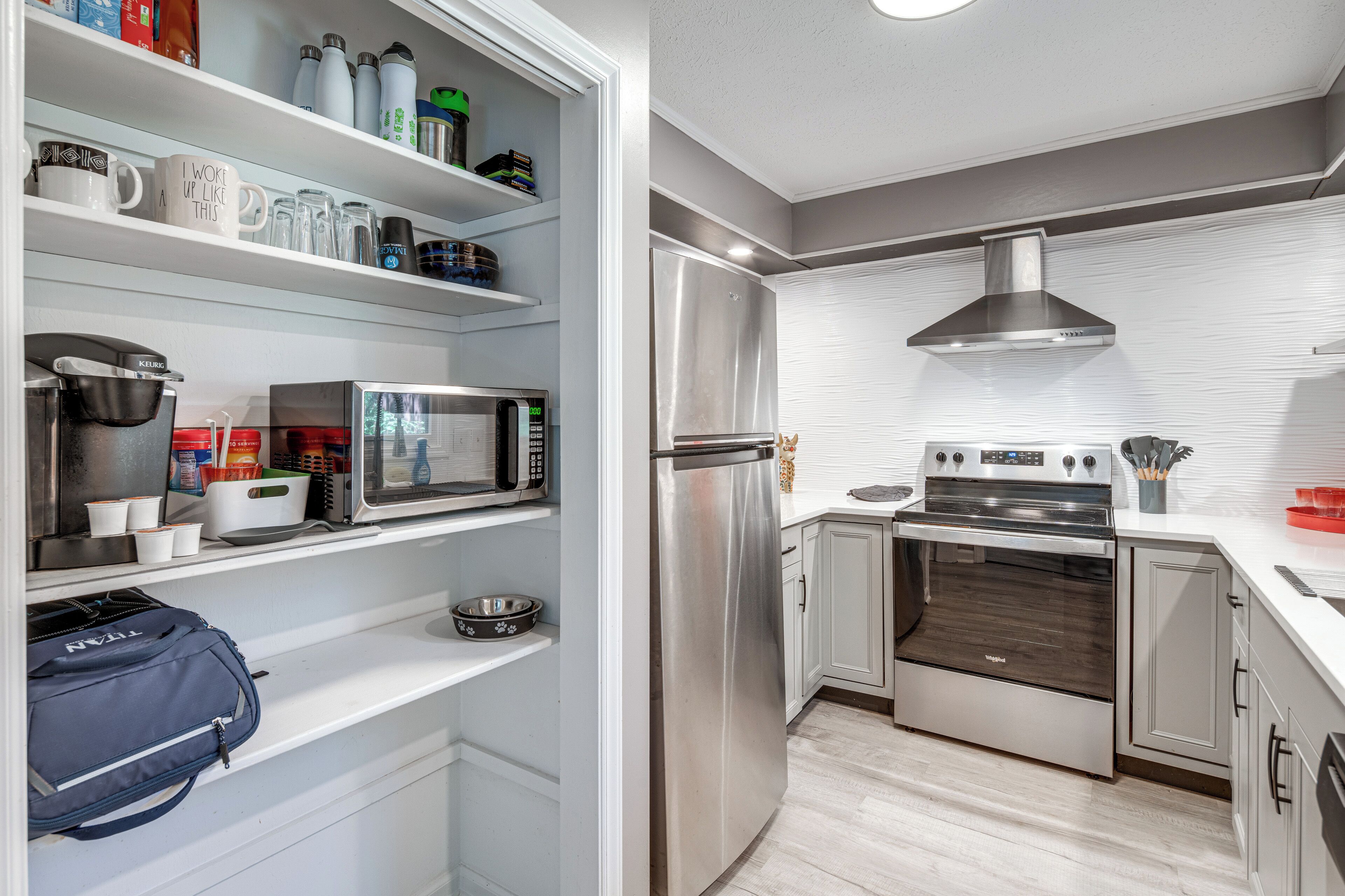 A modern kitchen with a built-in microwave, stainless steel refrigerator, and a double oven.