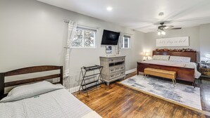 A bedroom with a wooden bed, a desk, a chair, a television, and a ceiling fan. - 1/2 Mi to Creation Museum: Home w/ Large Yard! (Petersburg)
