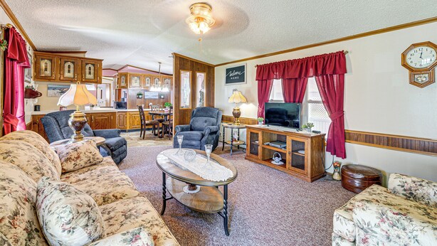 A cozy living room with a sofa, armchairs, a coffee table, and a television. - Paden City Home Near Ohio River! (Paden City)