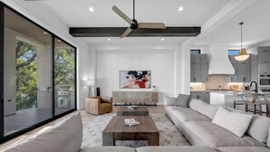 A modern living room with a sofa, coffee table, and a painting on the wall. - Ellen Lake Luxe | Concierge Services (Kingsland)