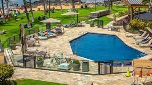 A pool area with a view of the beach, lounge chairs, and a covered seating area. - Mana Kai Maui Resort, #405a 1 Bedroom Condo (Kihei)