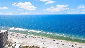 A beach with umbrellas and beach chairs, a clear sky, and the ocean. - NEW RENTAL! COMPLETELY RENOVATED! GREAT BEACH AND POOL VIEWS (Panama City)