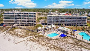 A resort with multiple buildings, a beach area, and a swimming pool. - NEW RENTAL! COMPLETELY RENOVATED! GREAT BEACH AND POOL VIEWS (Panama City)
