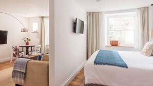 A hotel room with a bed, a desk, a chair, a television, and a window with curtains. - The Pilchard Press, The Pilchard Press on Harbourside in Mevagissey Village with FREE Parking (Saint Austell)