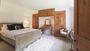 A bedroom with a wooden bed, a dresser, a chair, and a wardrobe. - The Barn - Two Bedroom Cottage, Sleeps 4 (Camelford)