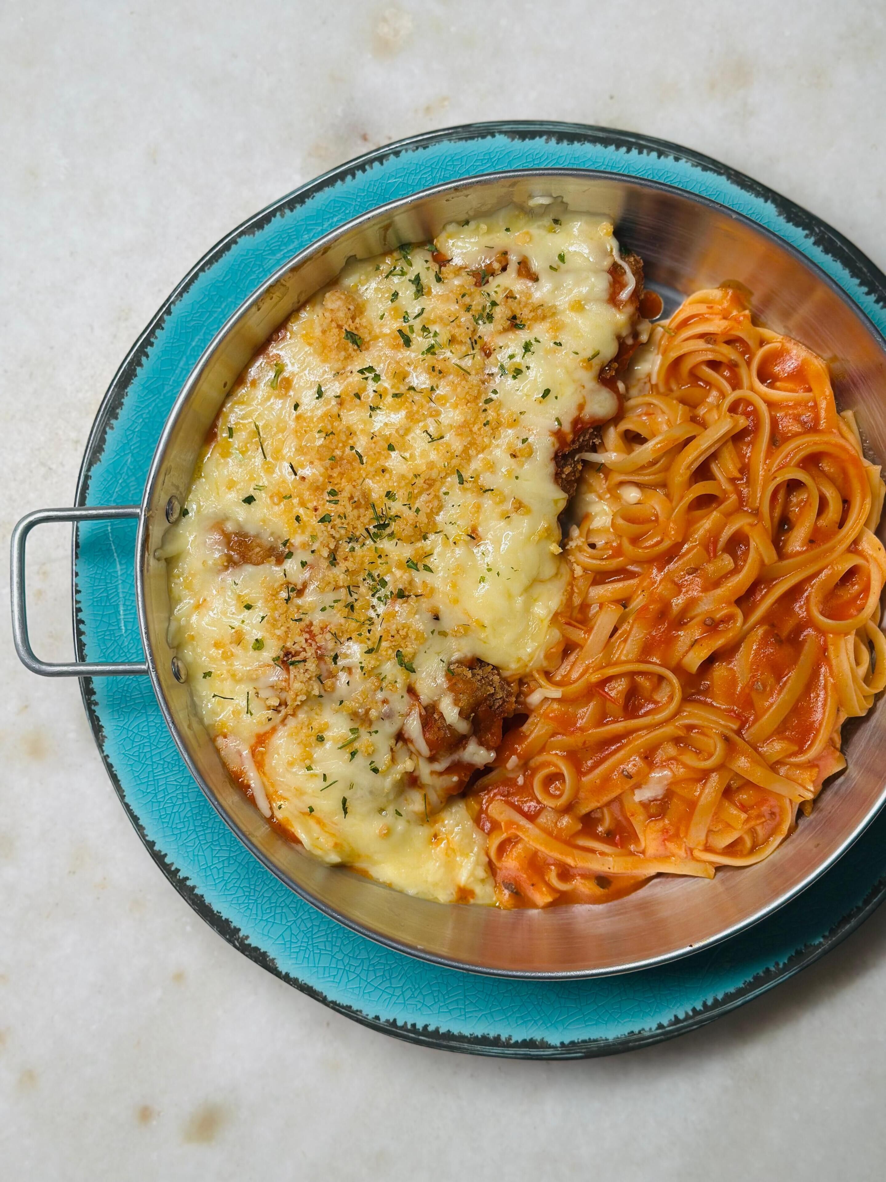 A dish of lasagna and pasta on a plate.
