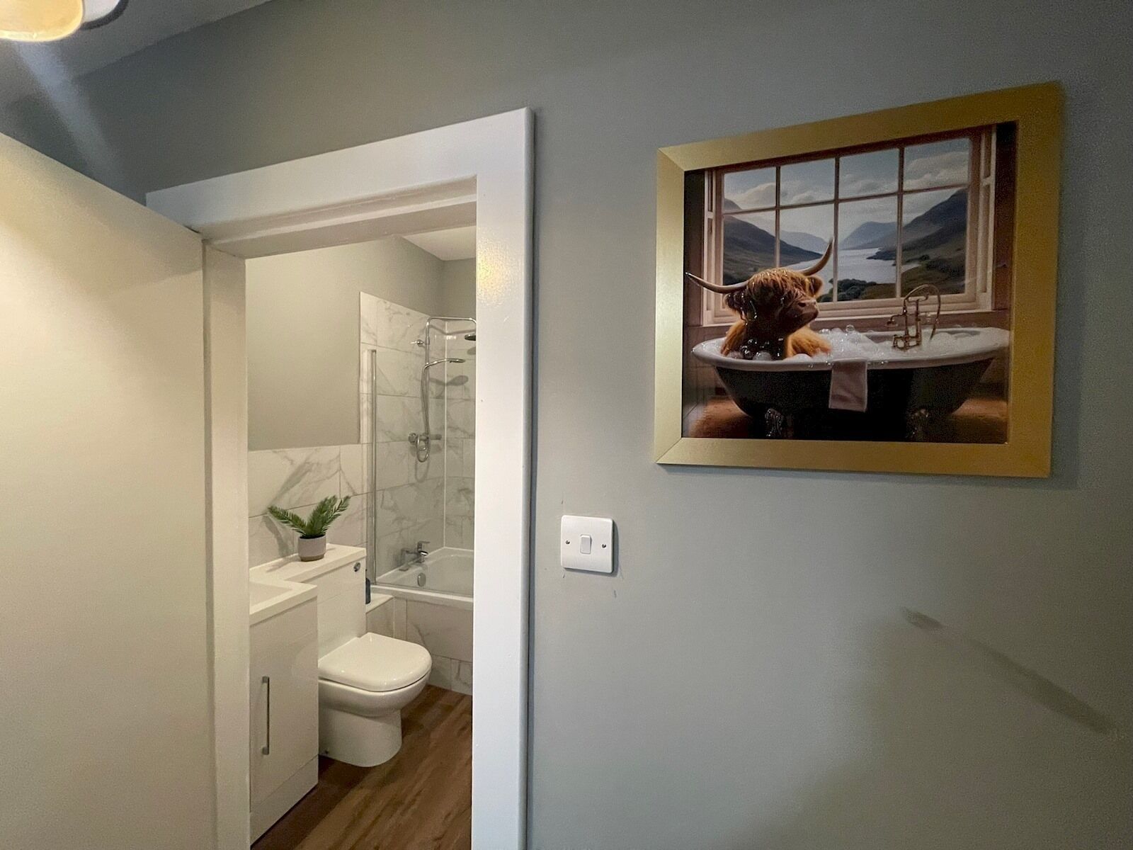 A bathroom with a shower, toilet, and sink.