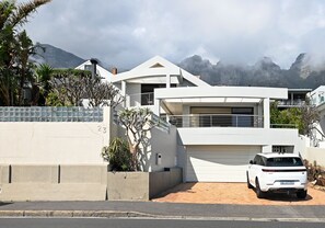 Stunning mountain views surround this two-story residence with a spacious driveway and balcony.