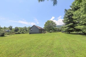A grassy field with a house and trees. - Sycamore Shade: 151 House, HOT TUB, Mountain Views (Afton)