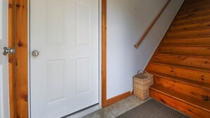 A wooden staircase leading to a white door with a metal handle. - Blue Rivers Loft on the Brew Ridge Trail (Afton)