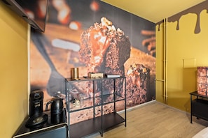 A modern interior with a large chocolate-themed mural, a coffee station, and a minimalist design. - The Chocolate Suites (Bruges)