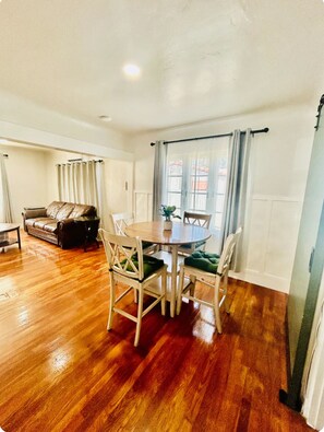 Cozy living and dining space with a round dining table and comfortable seating for four.