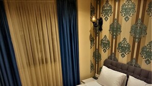 A neatly made bed with white linens and a decorative pillow. - By Historyal Hotel Due (Istanbul)