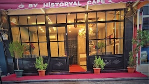 A cafe with a red awning and large windows. - By Historyal Hotel Due (Istanbul)