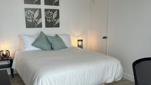 A neatly arranged bedroom with a bed, bedside tables, a desk, and a chair. - What a View!!! Chateau, Balcony incredible view of the Chateau! Free parking! (Lévis)