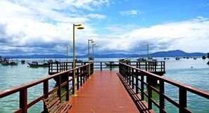 Stroll along the pier, taking in the views of the surrounding mountains and the boats in the water.