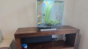 A fish tank on a wooden stand with a shelf below. - Free Private Transport From Any Dublin Port (Dublin)