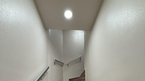 A staircase with wooden steps and metal handrails, leading to an upper floor. - Cozy studio in charming Santa Fe (Santa Fe)